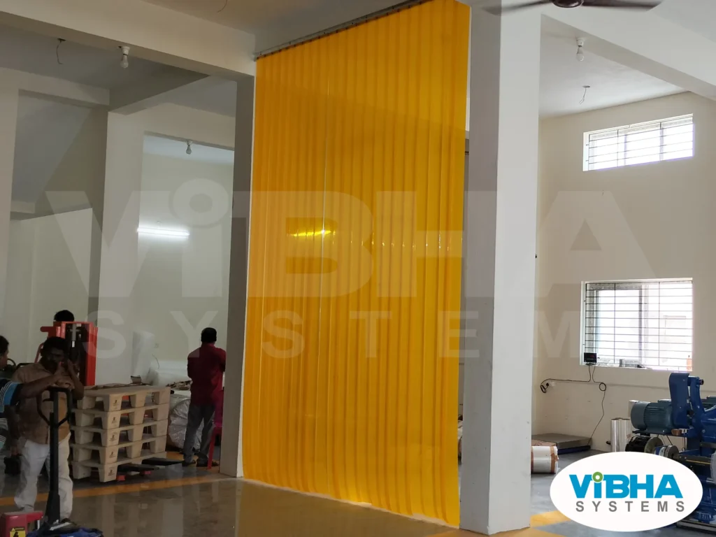 Insect amber PVC strip curtains installed in a food processing unit to prevent insect entry and maintain hygiene.