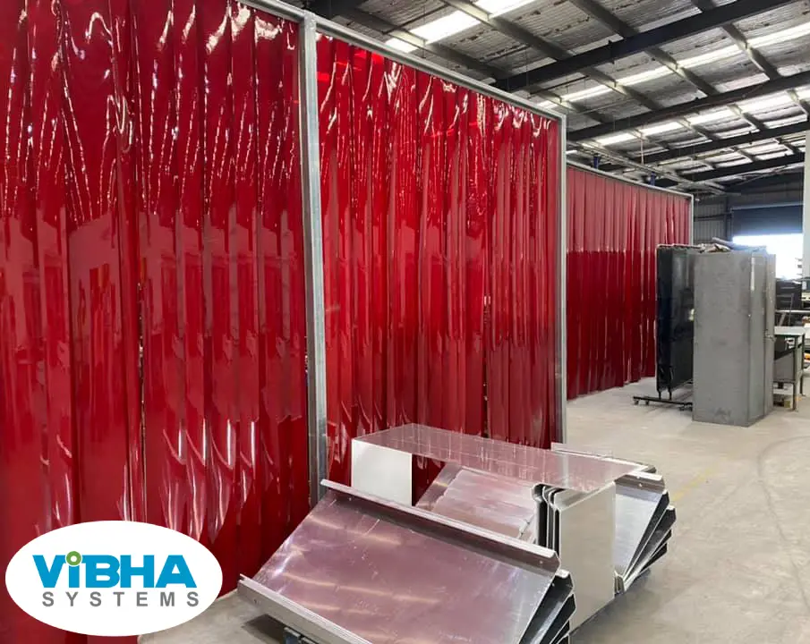 red color-tinted PVC strip curtains in a Chennai welding shop providing UV protection.