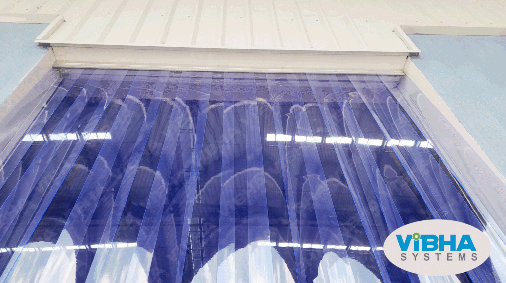 Transparent PVC strip curtains installed in a food processing facility to maintain hygiene and temperature control.