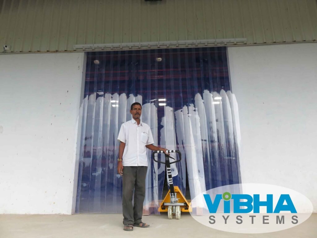 Clear PVC strip curtains installed in a warehouse in Chennai for dust, pest, and temperature control.